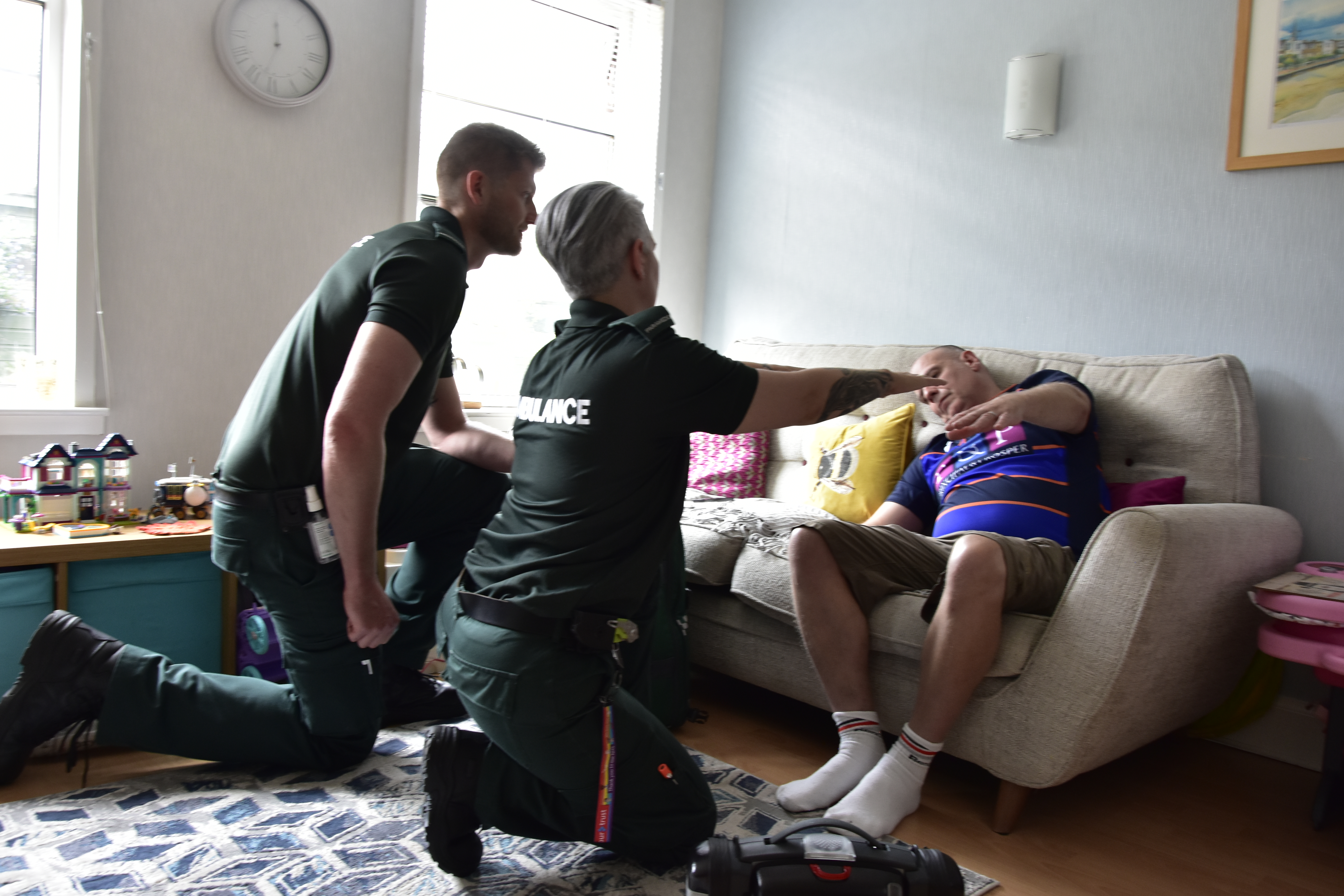 A crew treat a patient who has suffered a stroke