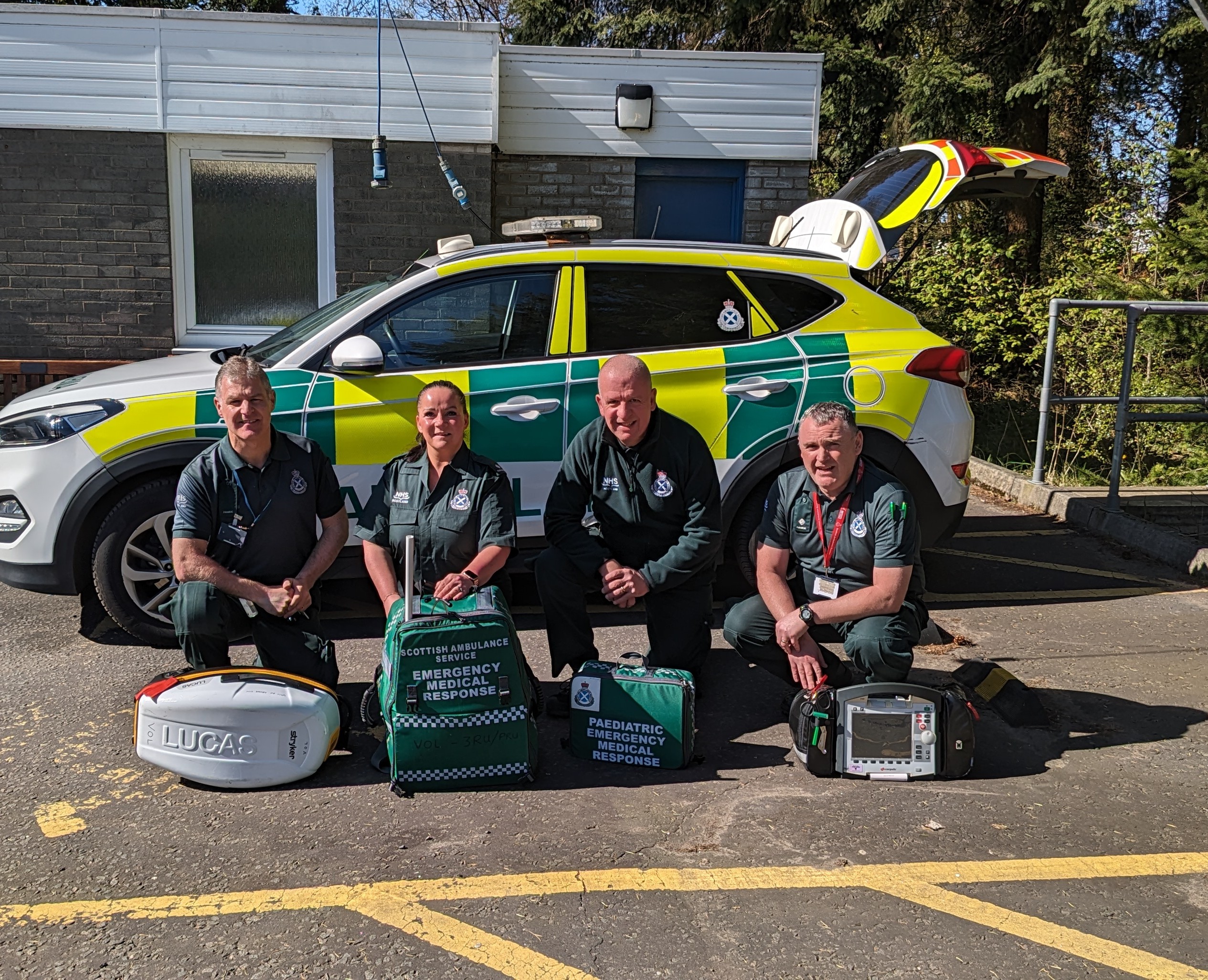 Group picture of the 3RU Responders in front of am ambulance car
