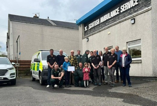 COmmunity members presenting certificate to Hector