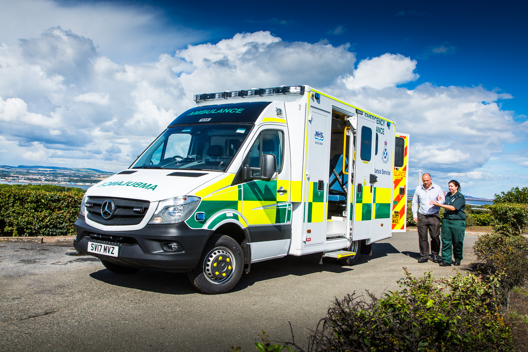 A patient is helped by a Paramedic to an ambulance