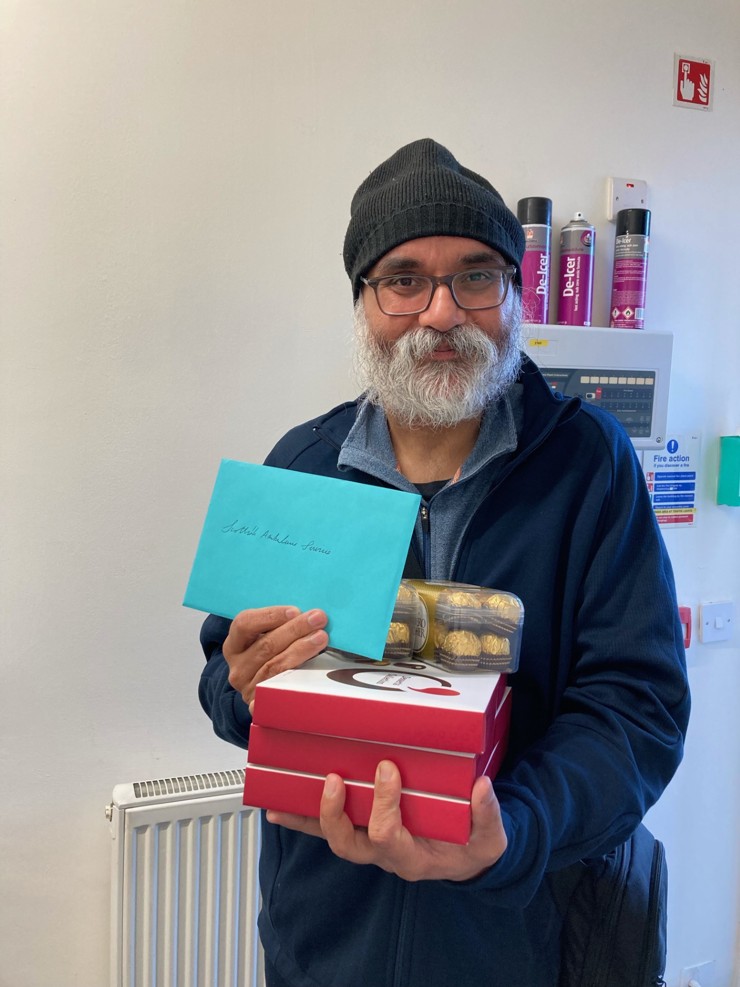 Patient Parminder with cards and chocolates for staff