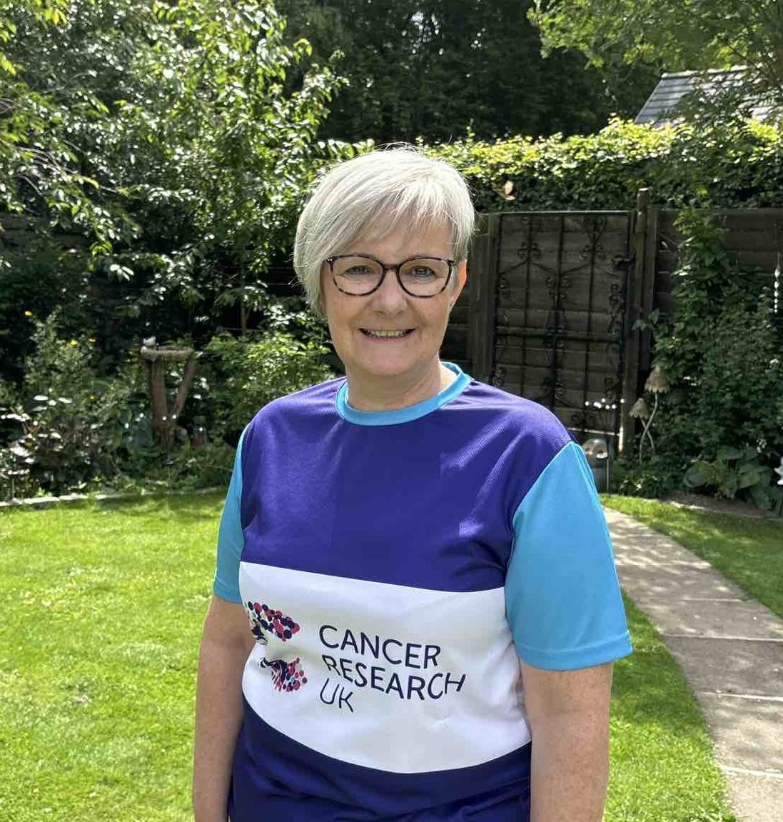 Velda in running top with Cancer Research UK logo