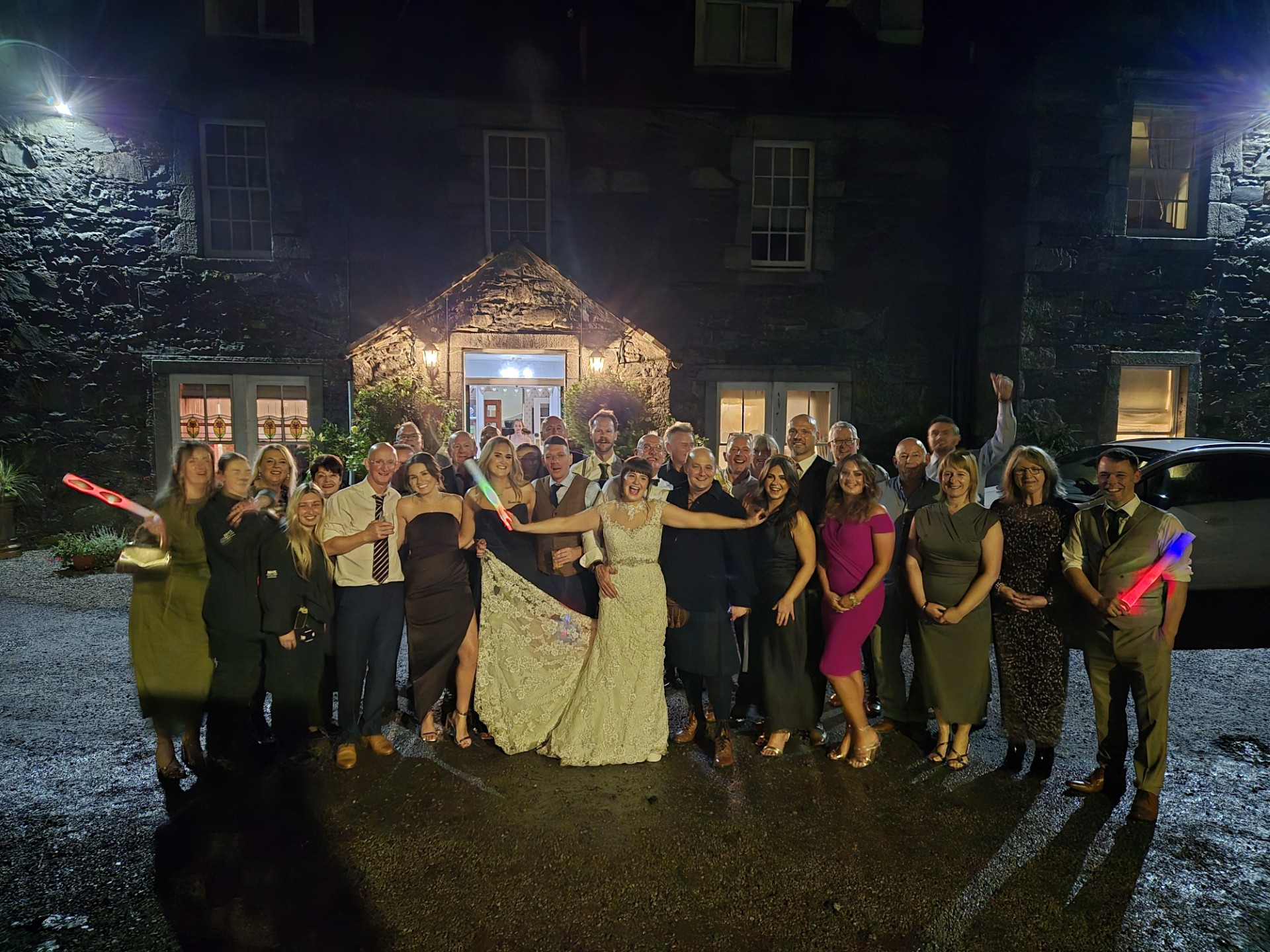 Group picture of everyone celebrating with Sarah's arms open in the middle