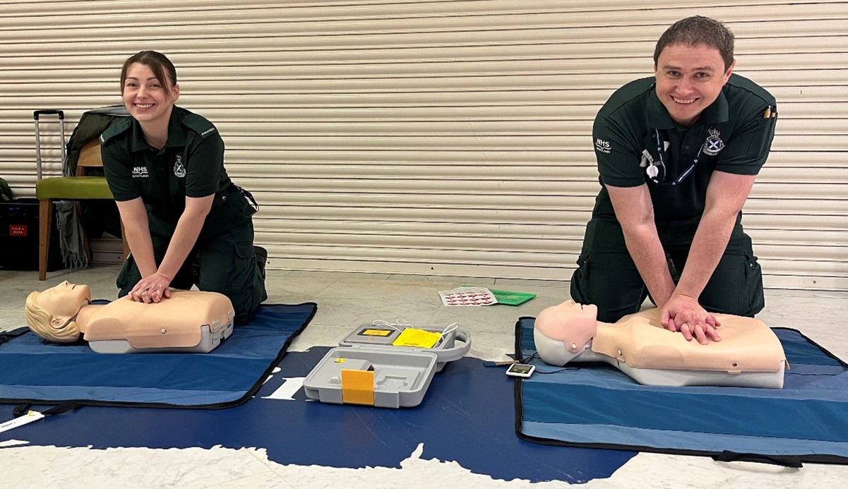 Two SAS paramedics performing a demonstration of CPR on two CPR dummies.