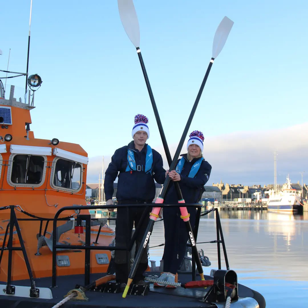 Mhairi and Allan with their row boat on the water