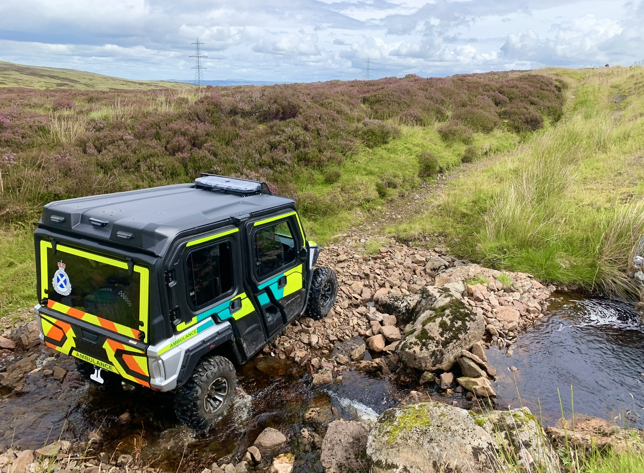 A Wolverine all terrain ambulance going across a burn