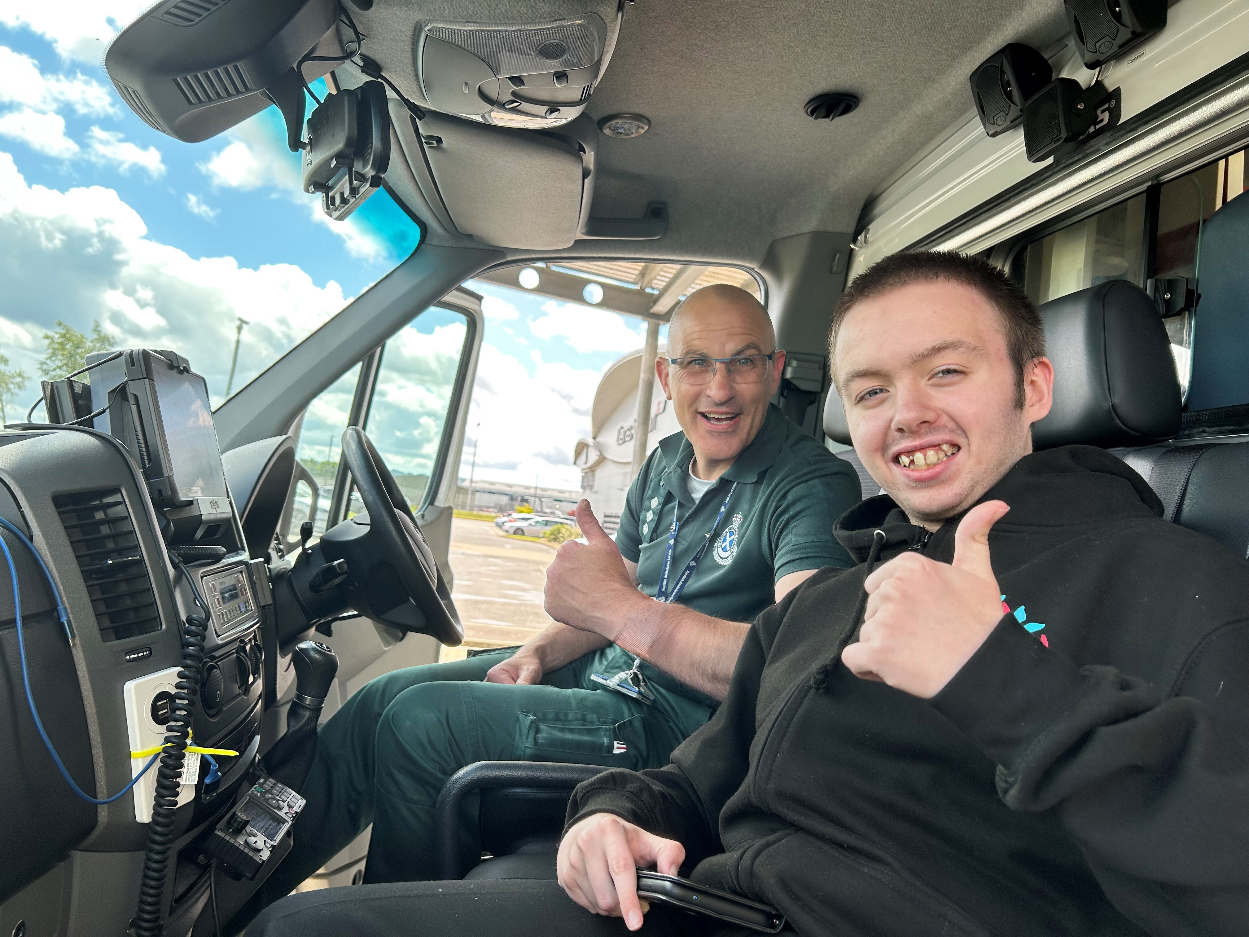 Pupil William Finan With Air Ambulance Paramedic John Pritchard sat in the cockpit of the air ambulance.