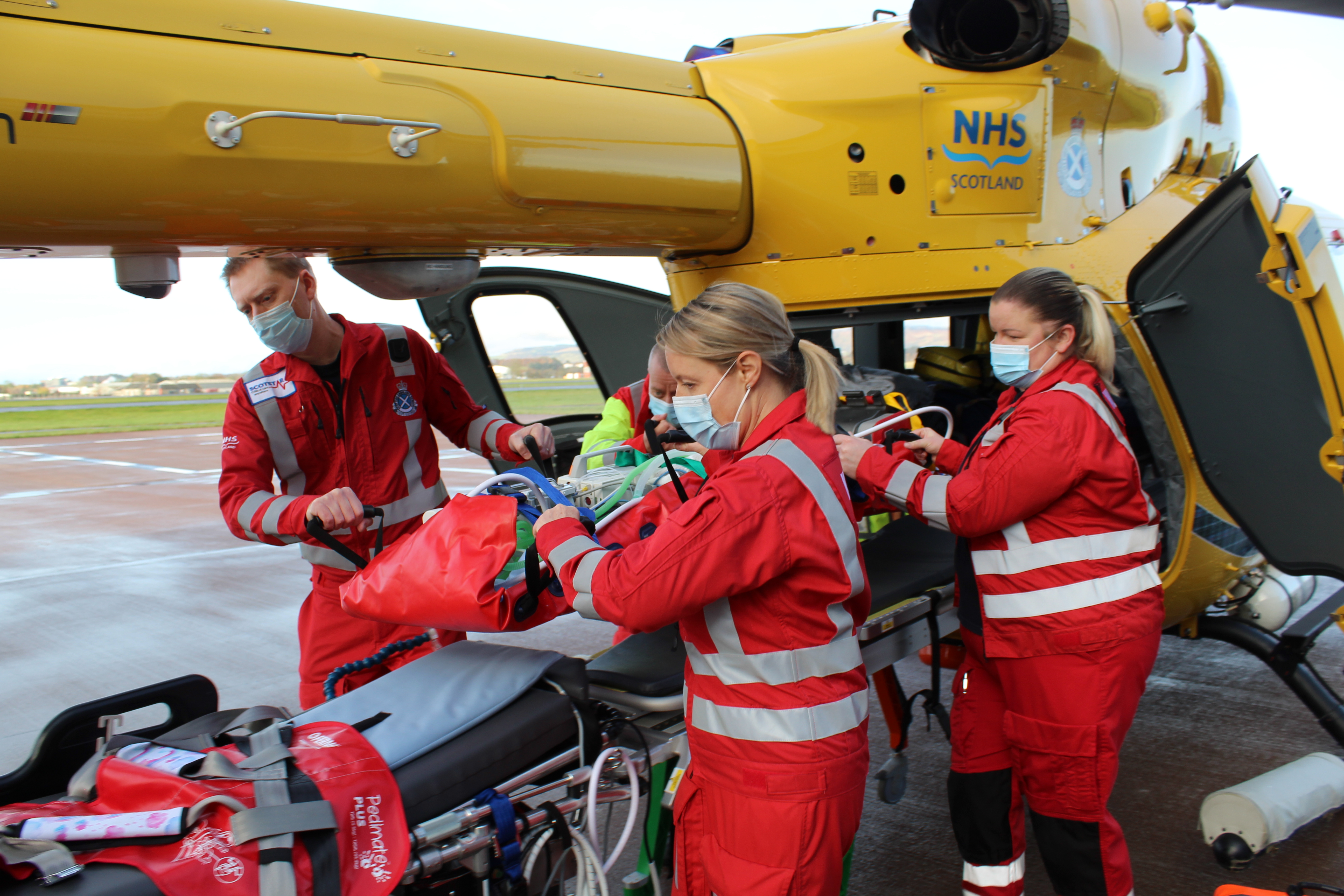 A crew take a child out of an air ambulance helicopter