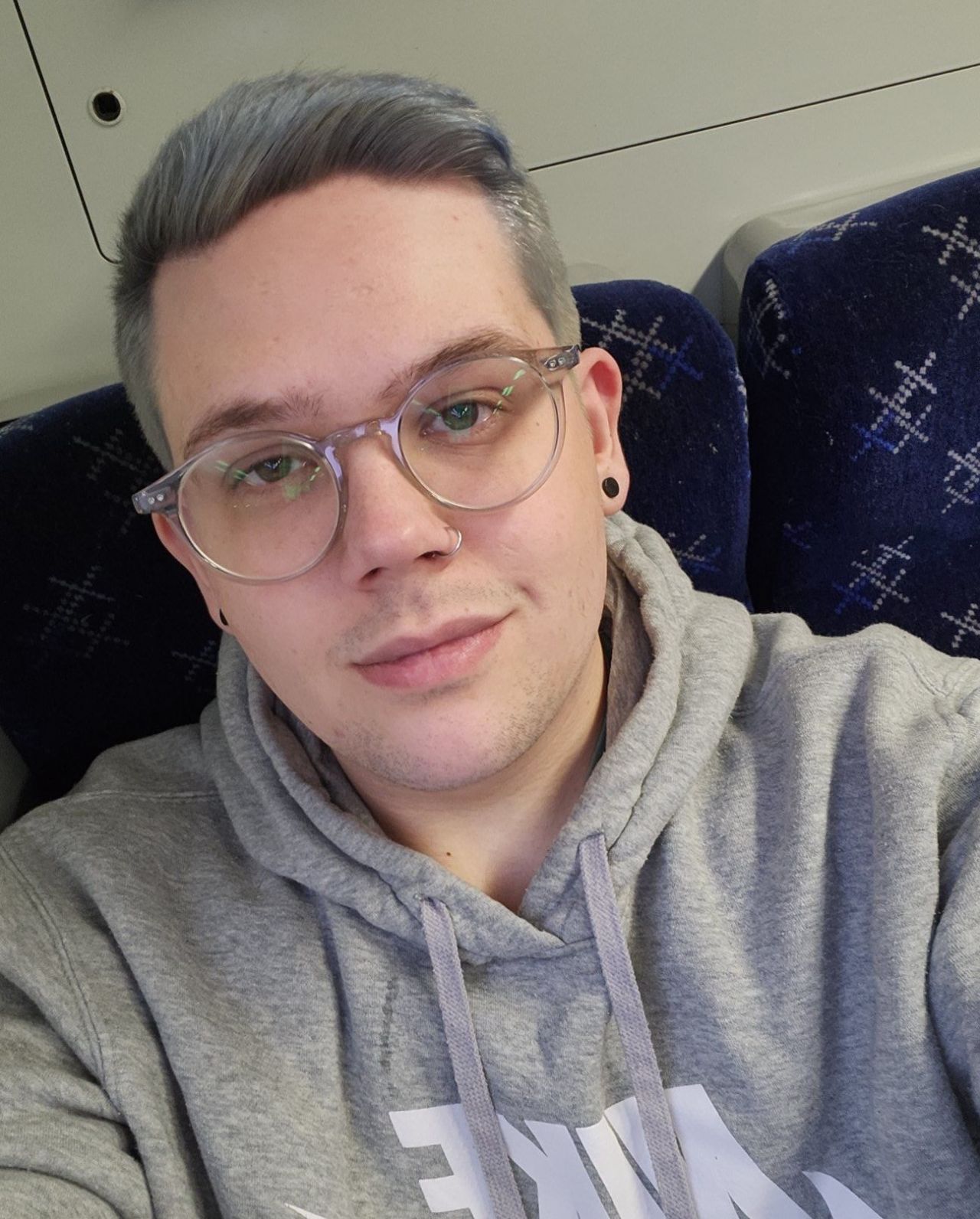 Declan takes a selfie type photo at home in his casual clothes