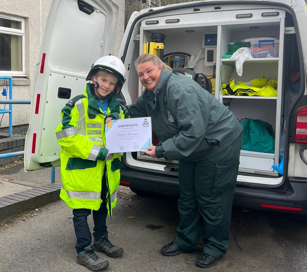 SAS staff member presenting certificate to Hector