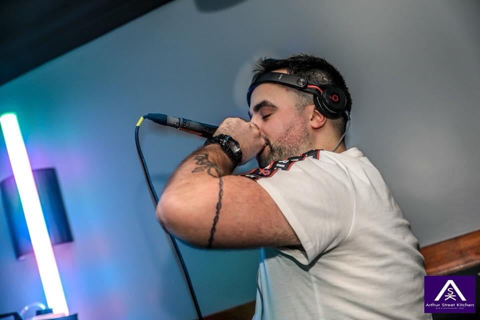 DJ Dean Burnett speaking into a micorophone 