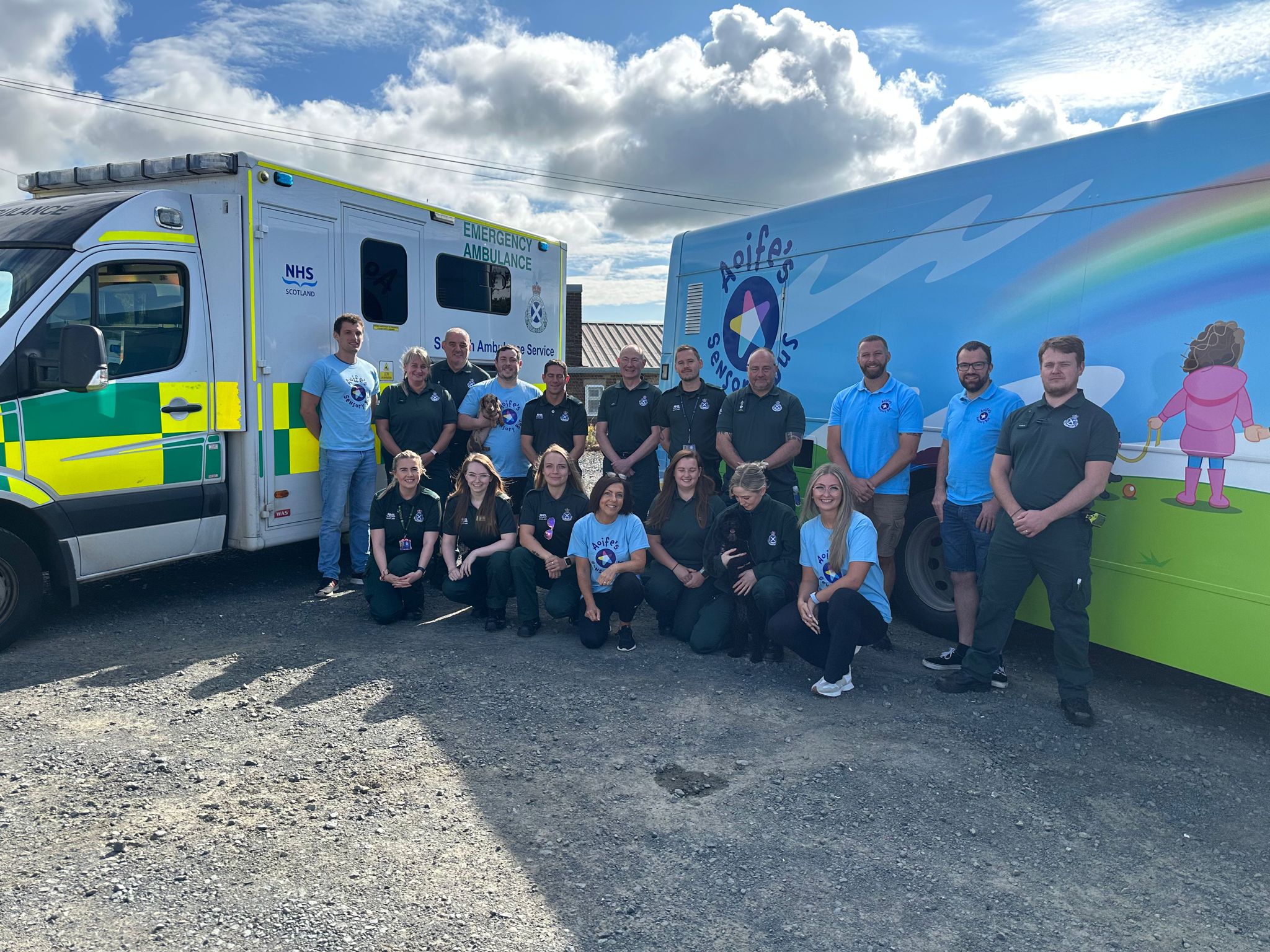 ambulance and hospital staff in front of ambulance and sensory bus