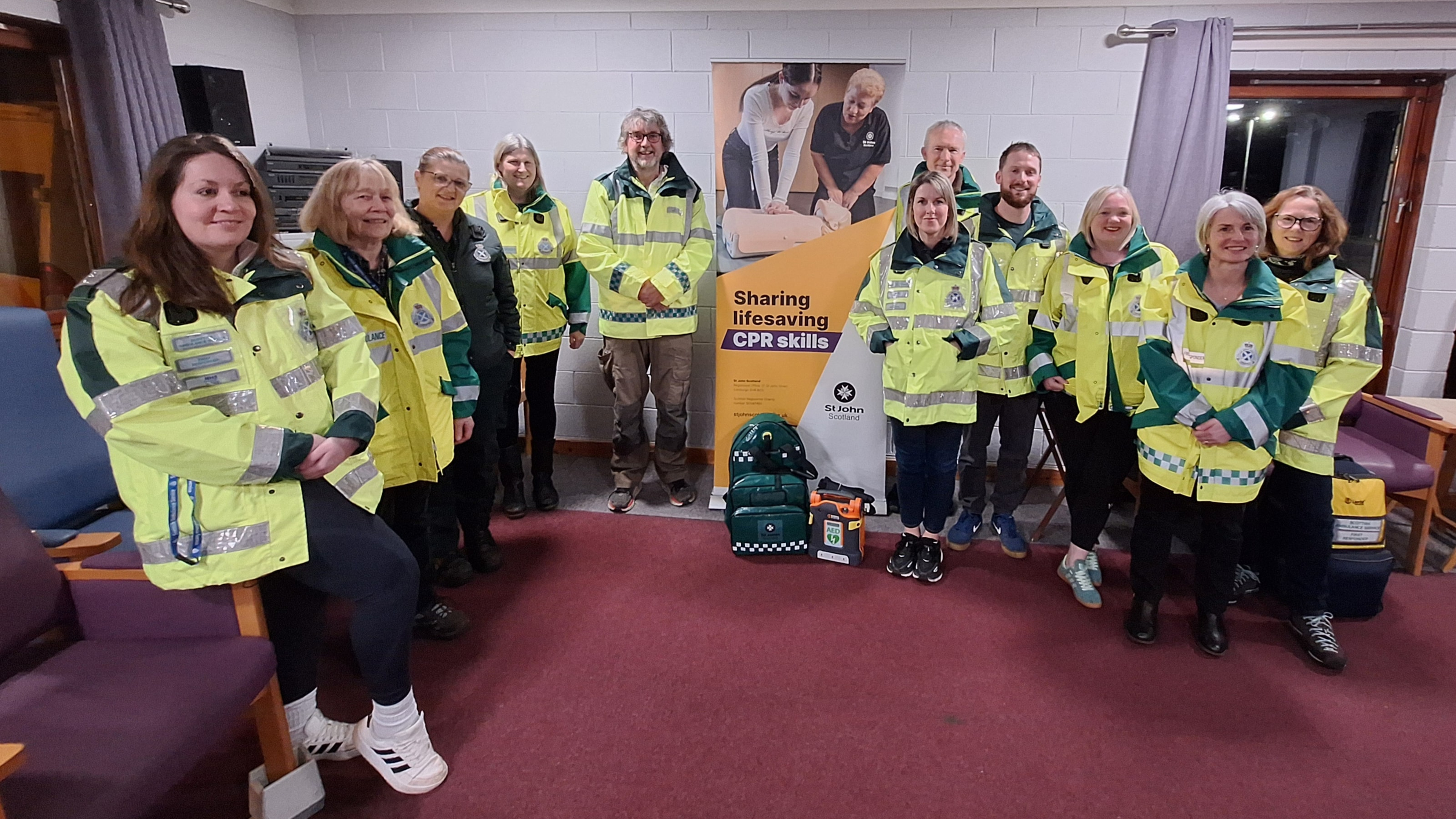 A group of 10 community first responders and one SAS crew member standing together smiling.