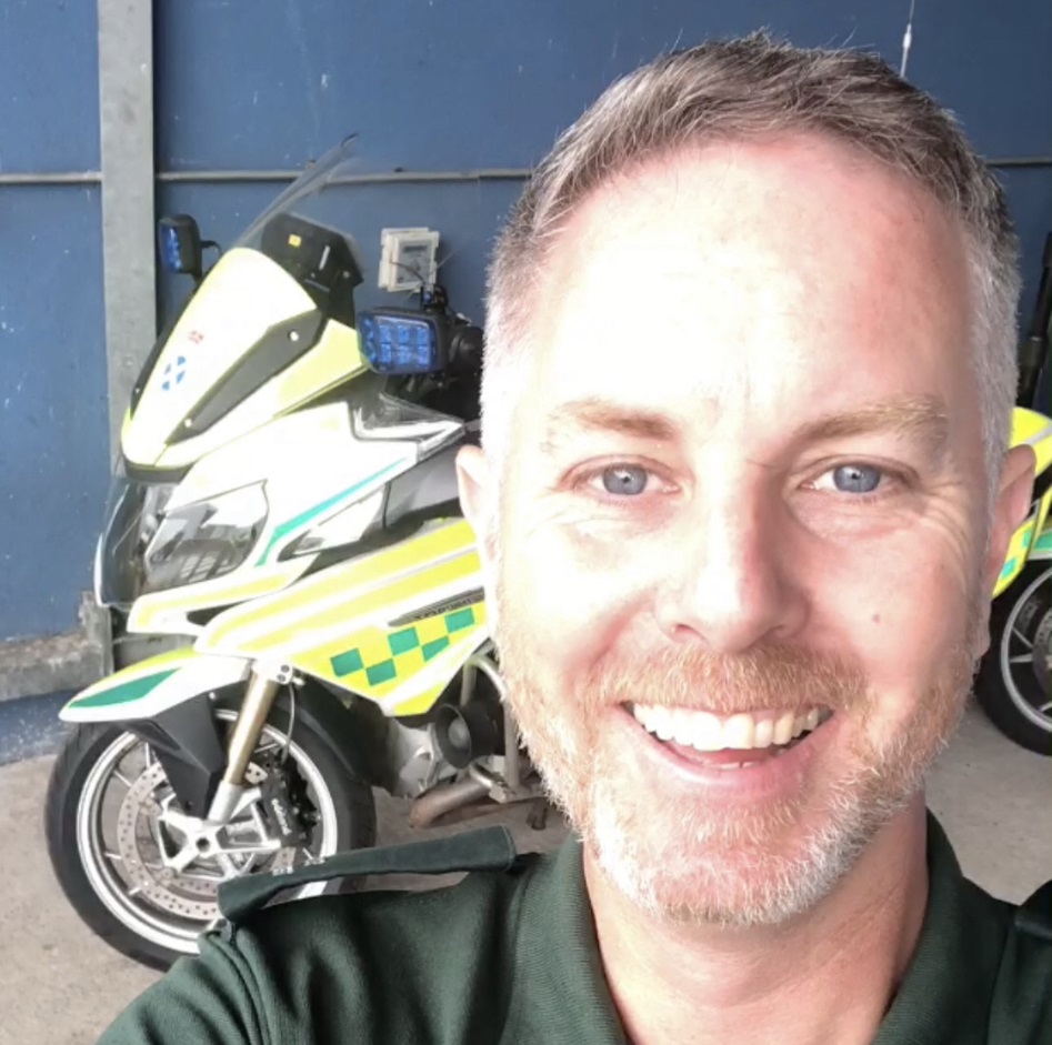 Iain in work uniform at home