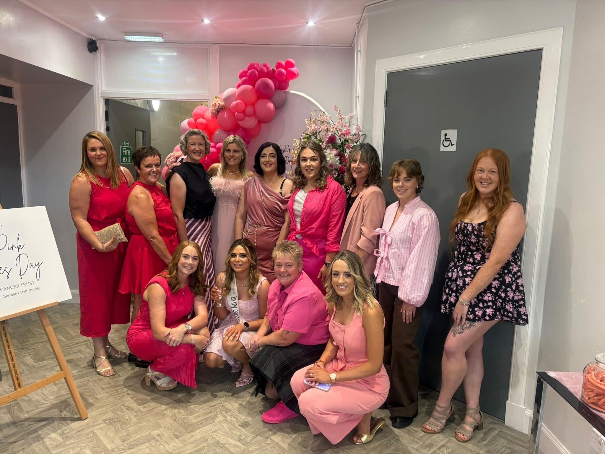 Kayla and SAS colleagues dressed in elegant pink apparel for the Ladies' Day