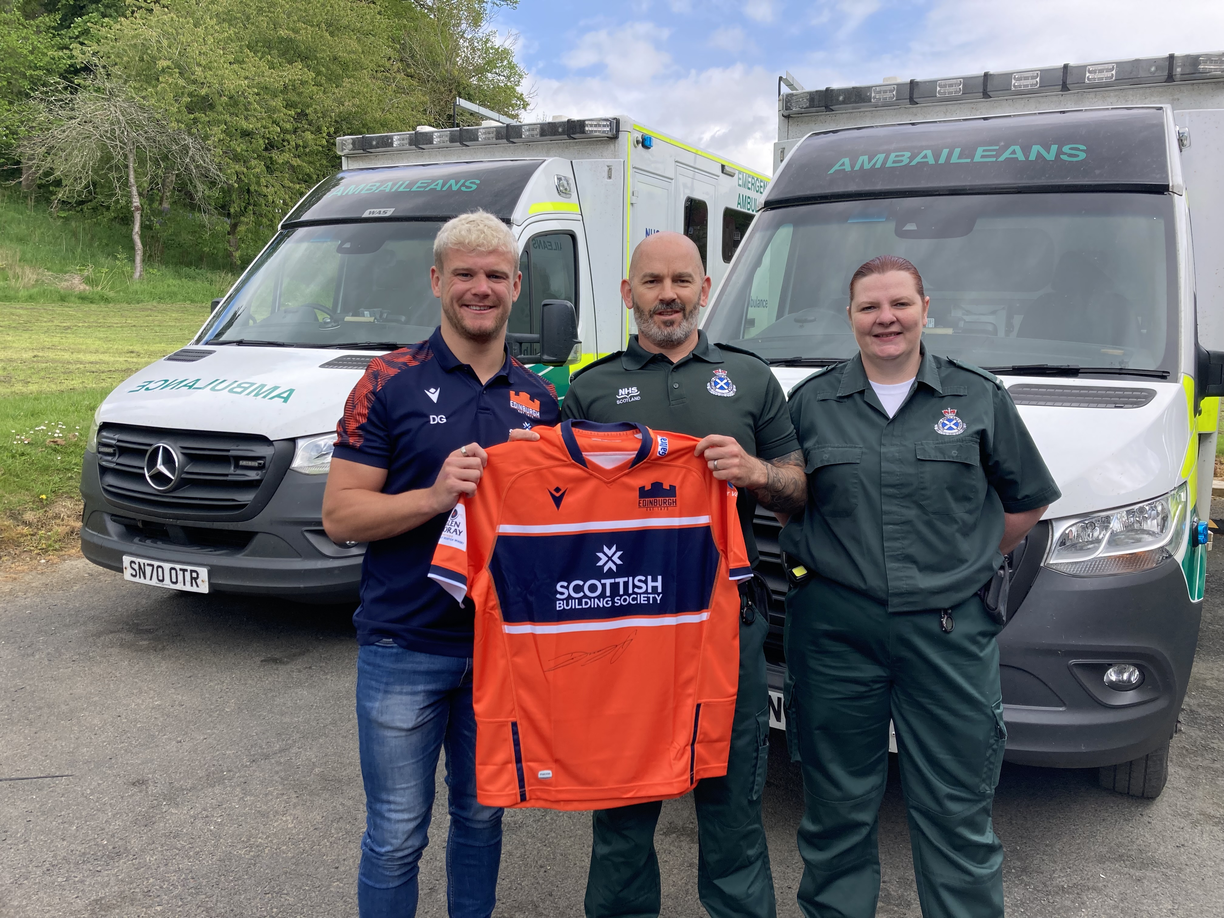 Darcy presenting signed jersey to Hawick staff members