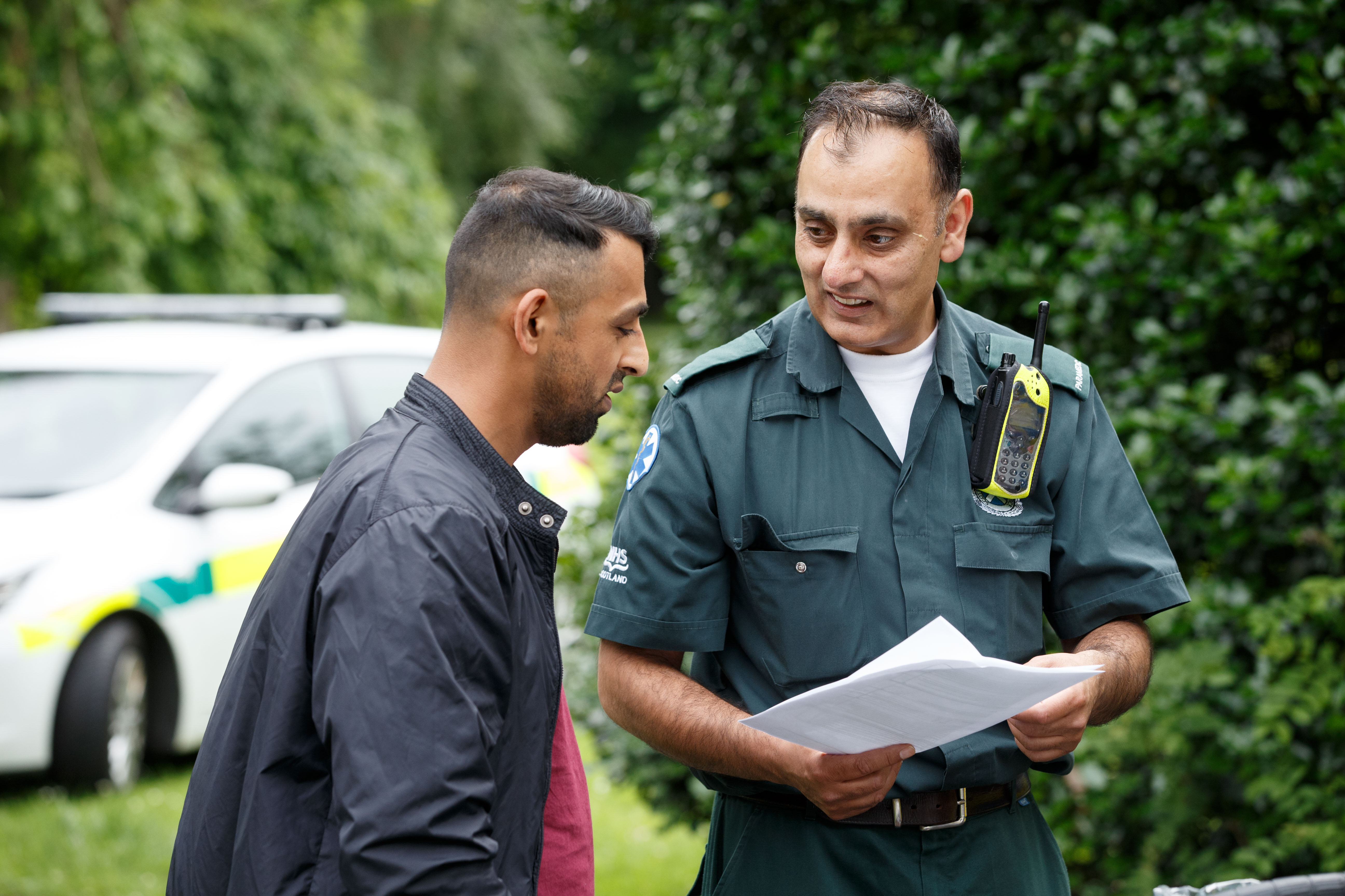 A Paramedic talks to a member of the public