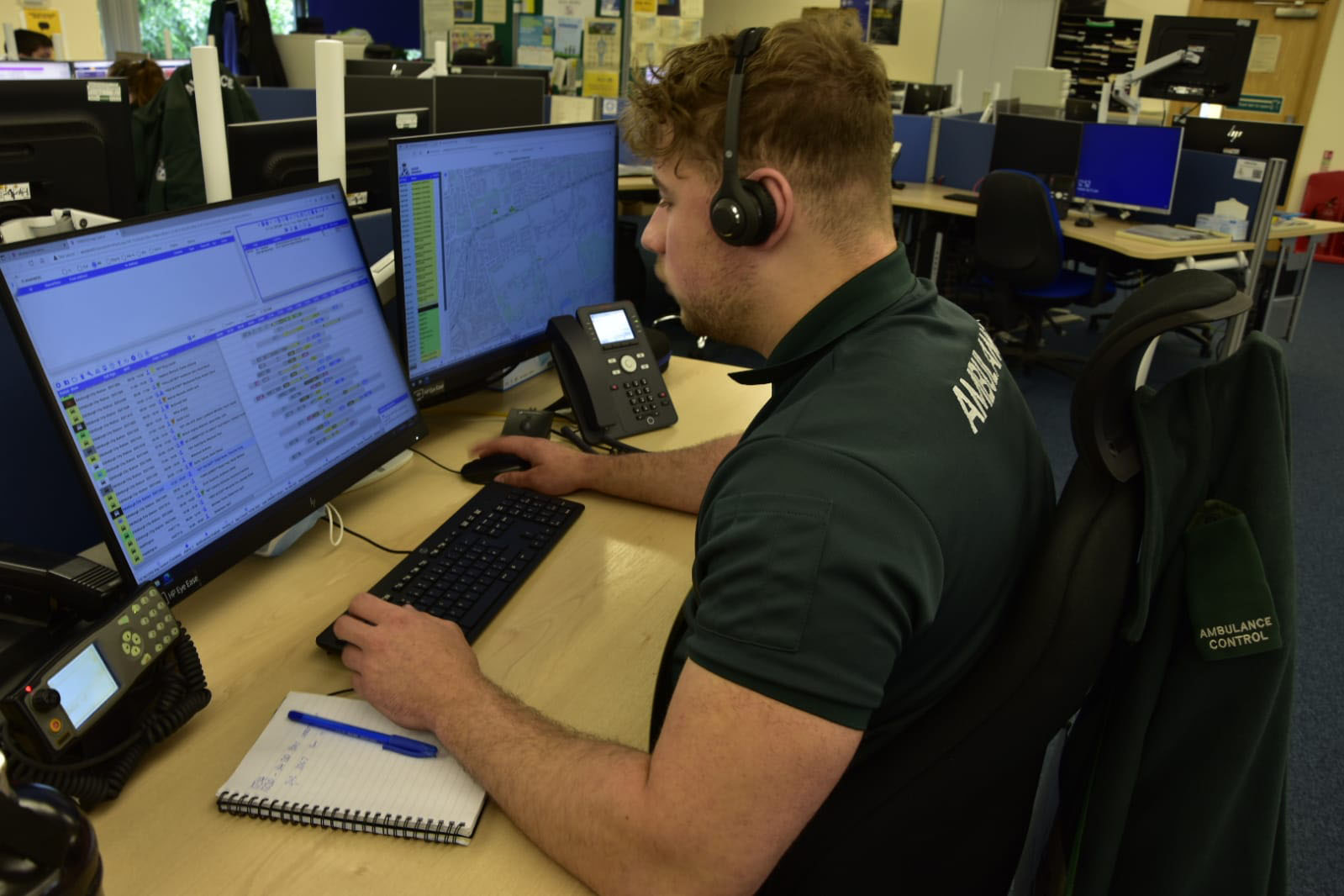 A Call Taker within an Ambulance Control Centre taking a call