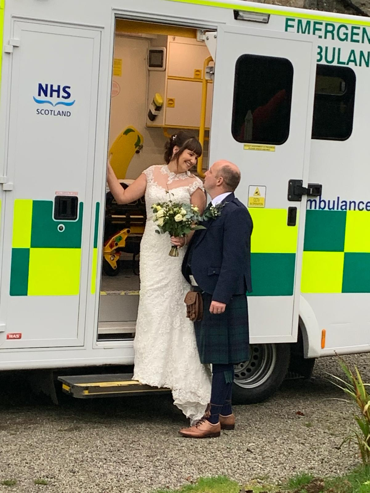 Wayne and Sarah look into each other's eyes in the bottom of an ambulance on their wedding day