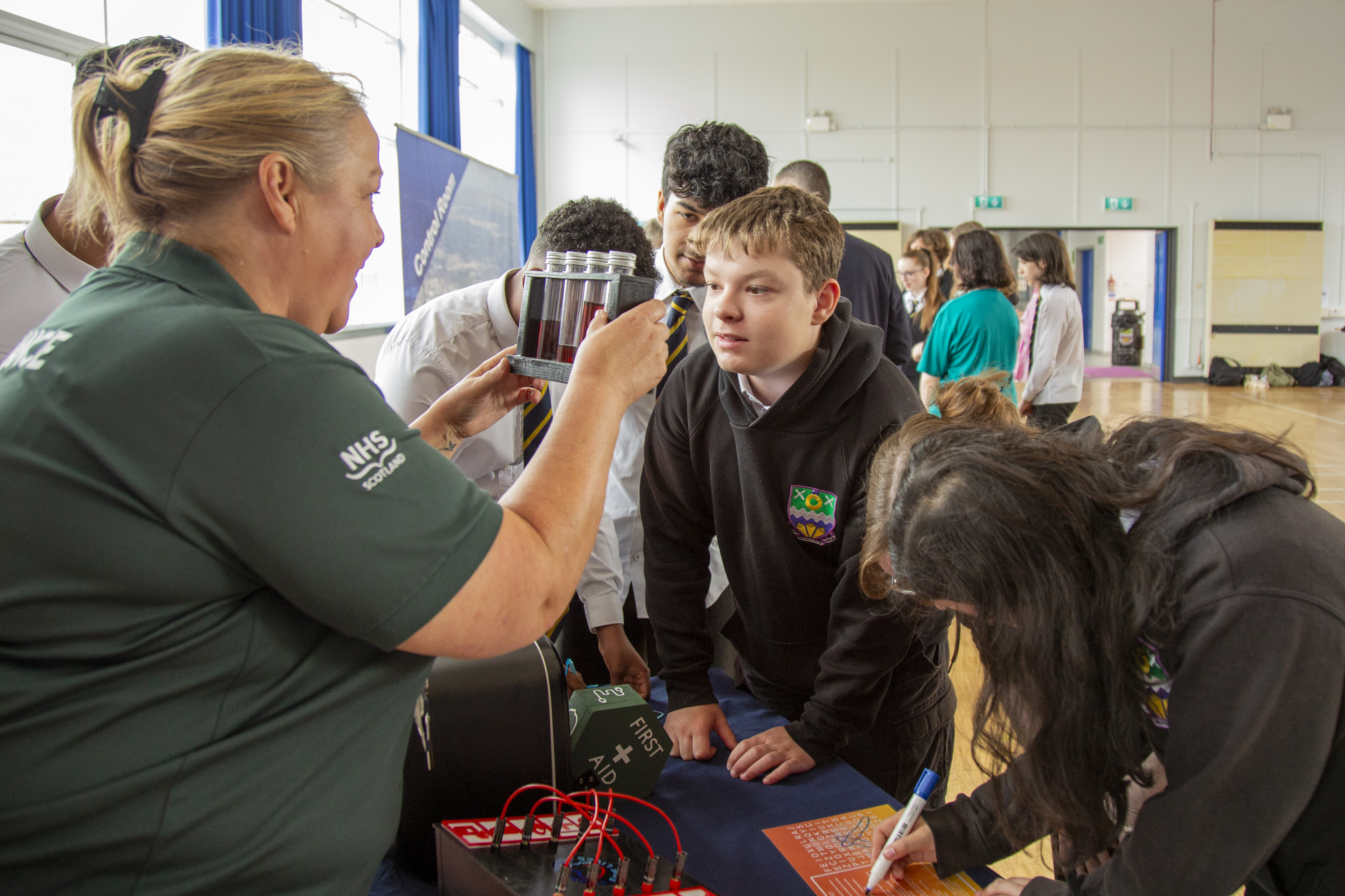 A Paramedic shows some pupils first aid