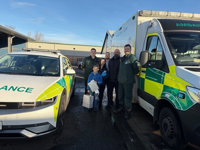 Group picture of Christopher and Lee and his wife with the SAS staff who assisted him on the day