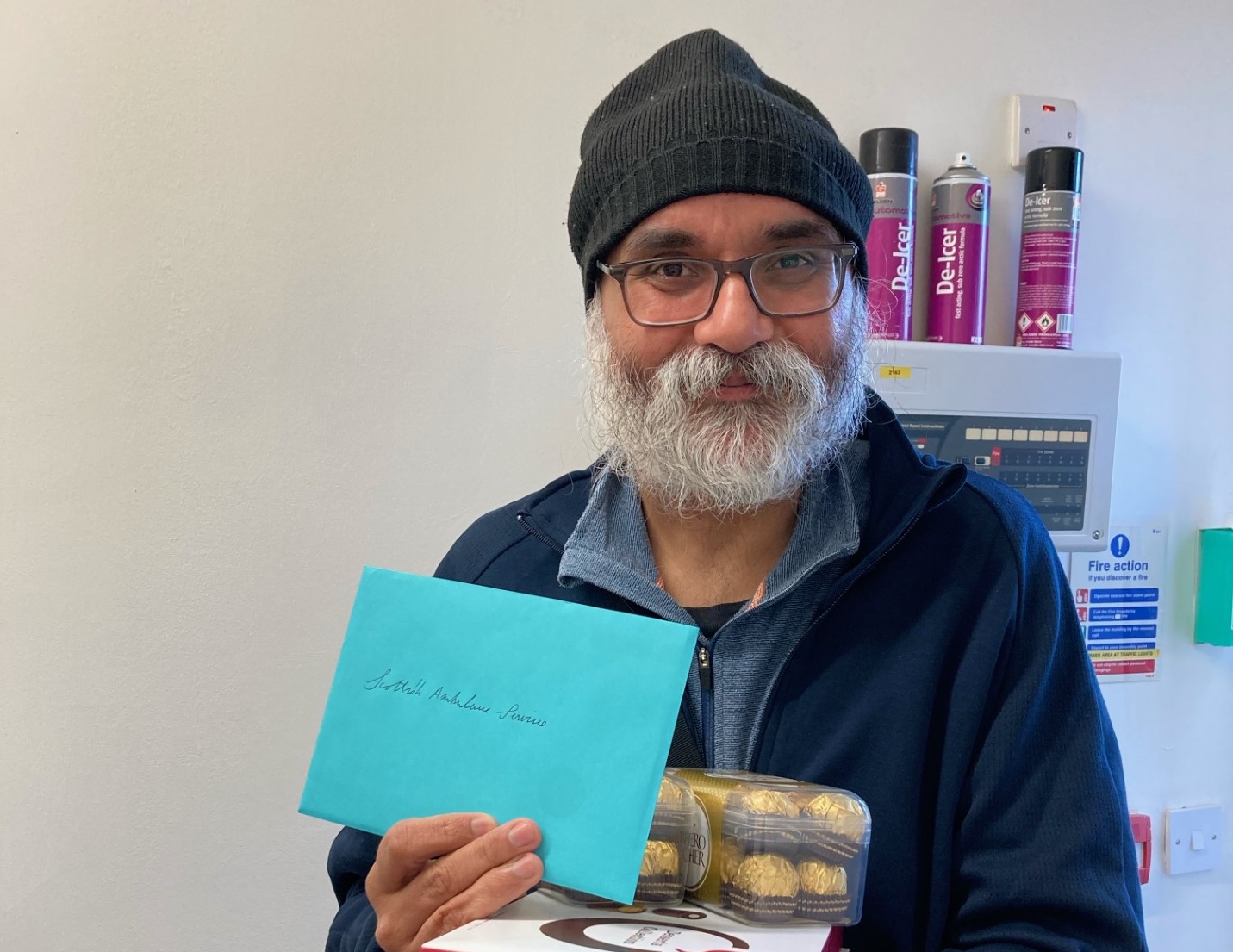 Patient Parminder with cards and chocolates for staff