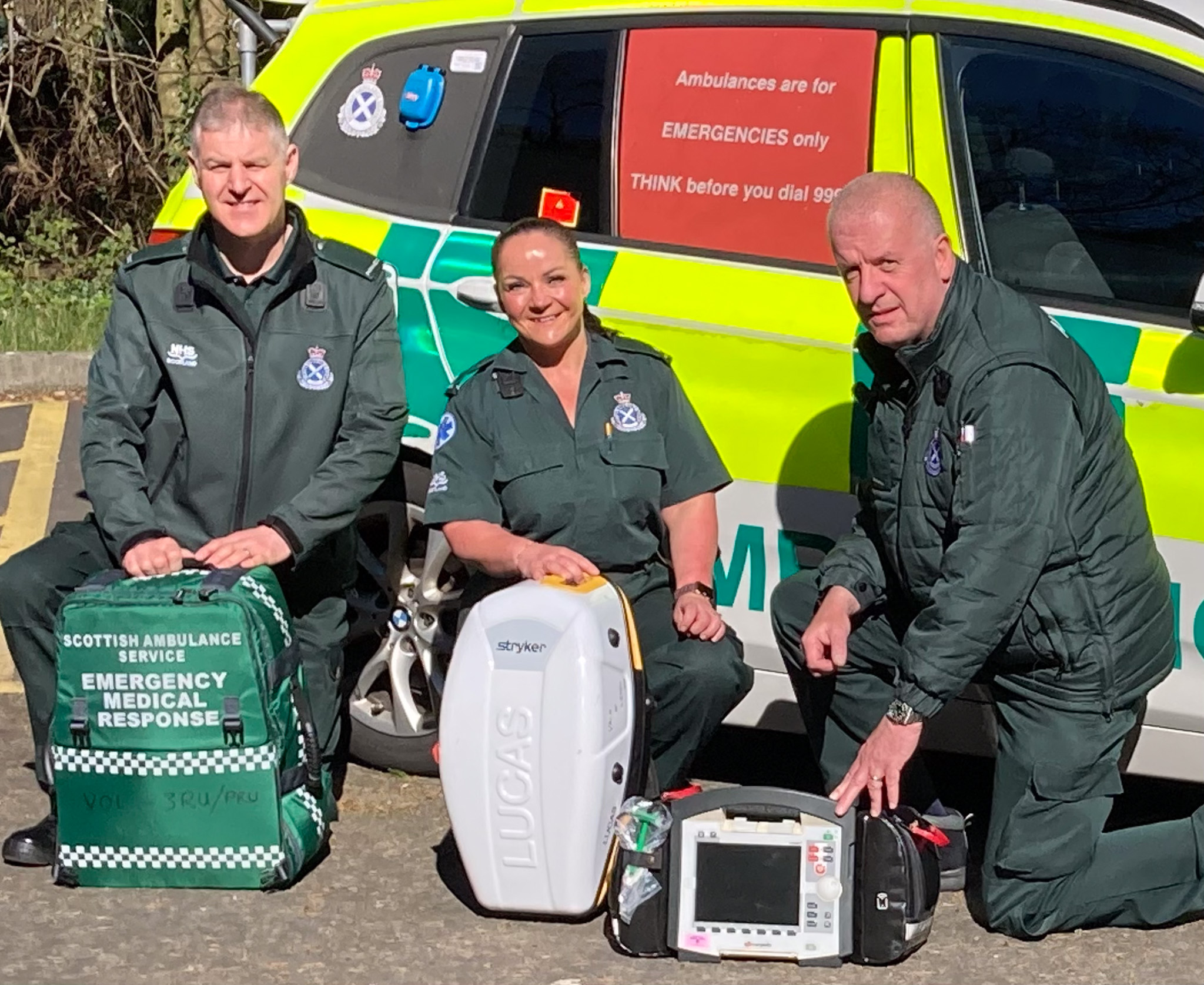 Group shot of 3RU responders in front of an ambulance car