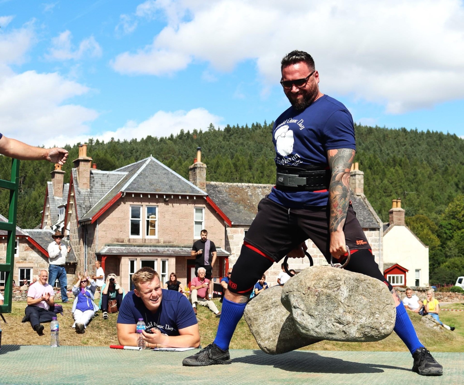 Calum lifting heavy stones at strongman competition