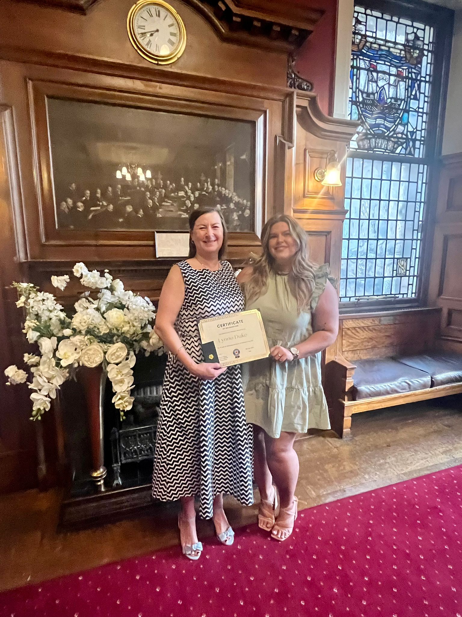 Lynne shows of her certificate